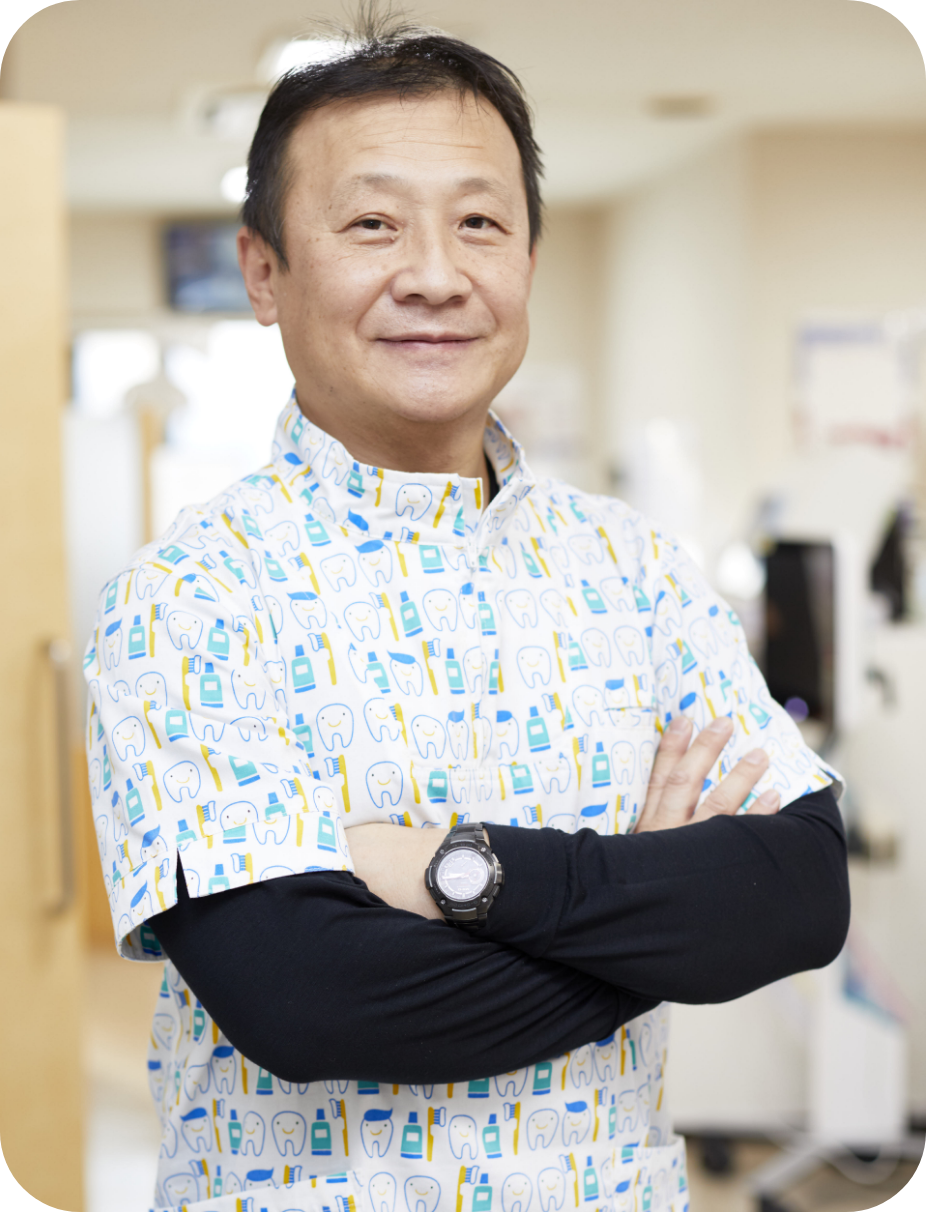 幸田歯科医院の院長、幸田慶英先生の笑顔のポートレート